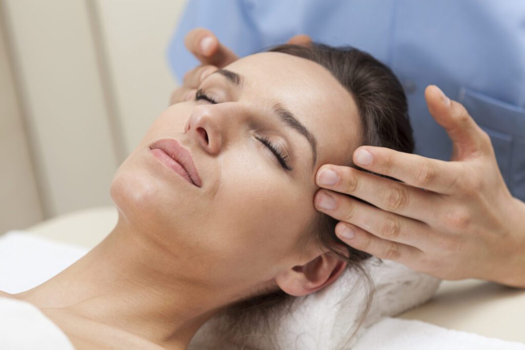 female brown hair patient laying down and doctor touching face