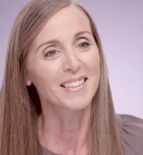 Light brown hair female with brown shirt