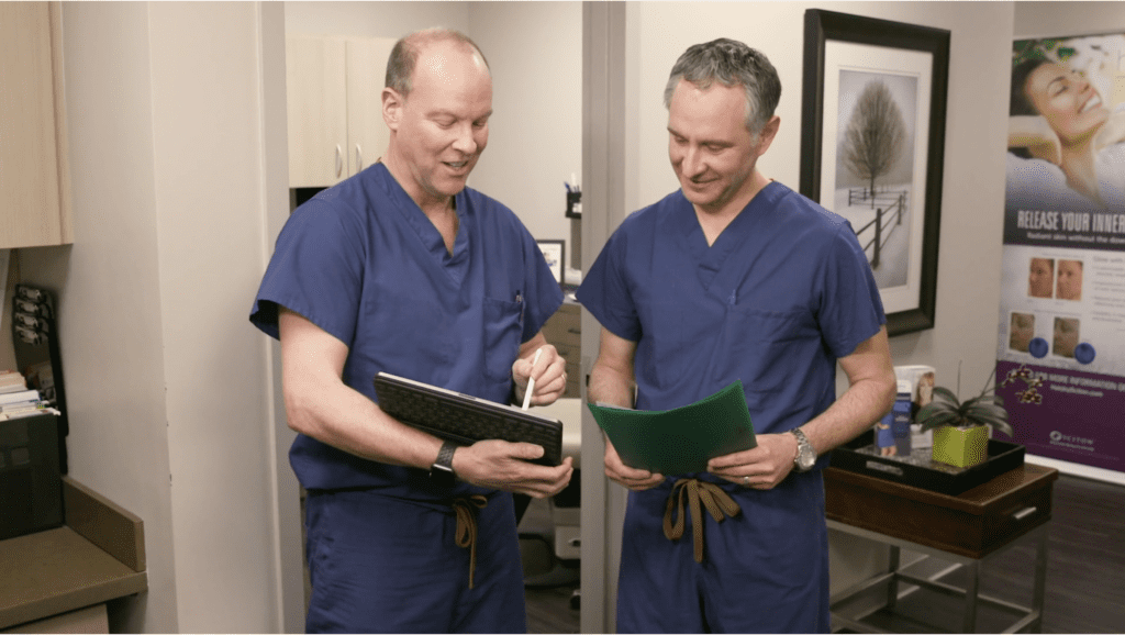 dr ambro dr chappell reading literature in blue scrubs