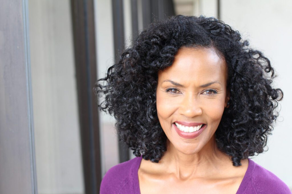 African american female with brown hair in a purple dress