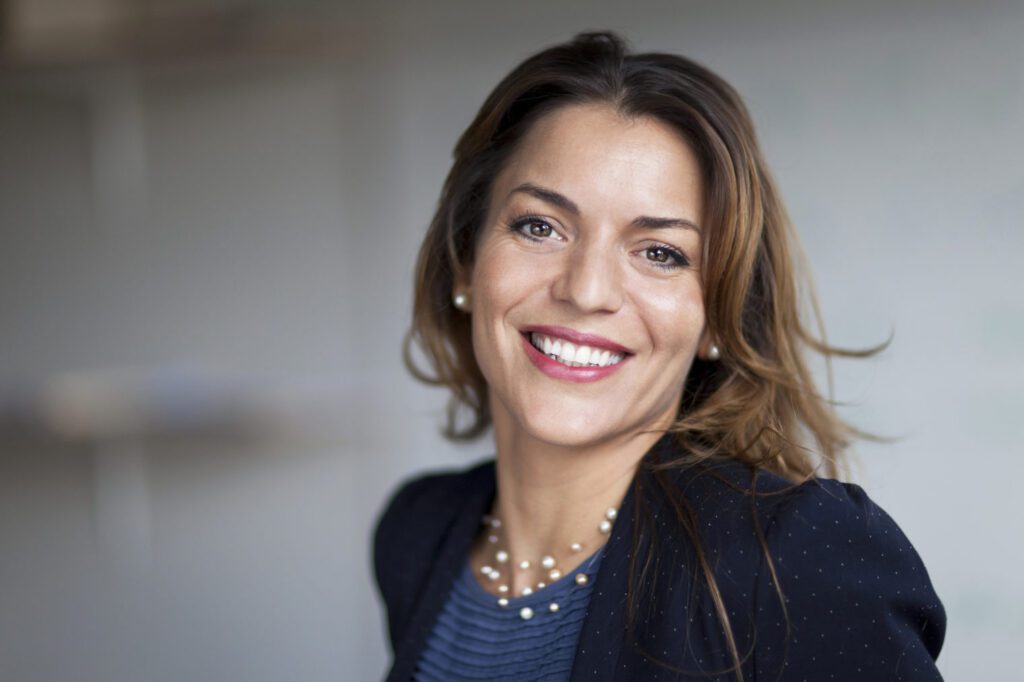 brown hair female with blazer and blue shirt